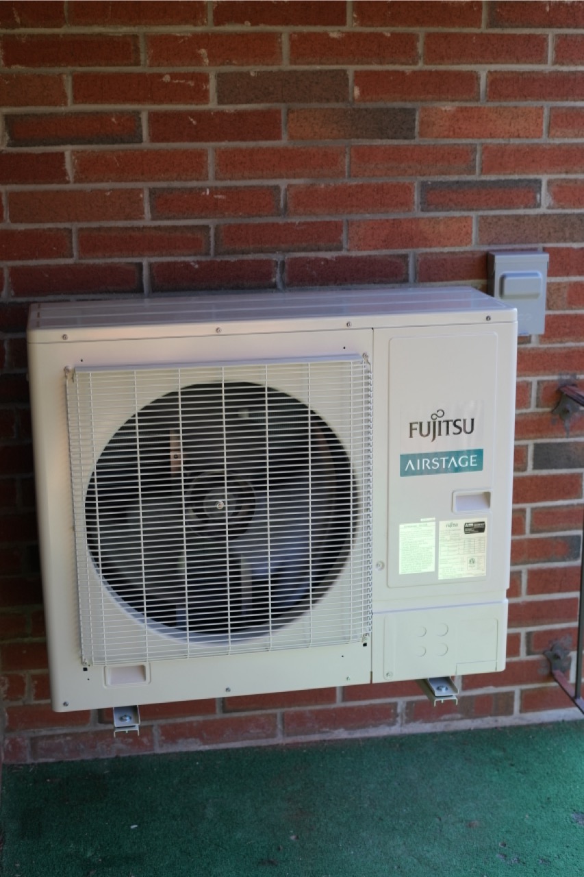 Fujitsu Airstage mini split condenser installed outside home