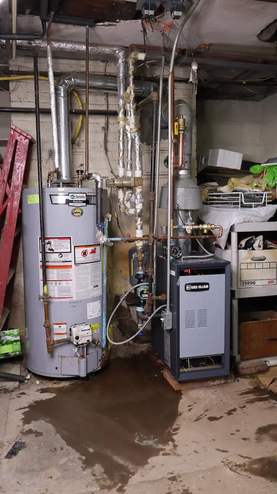 Failing water heater with water on the floor