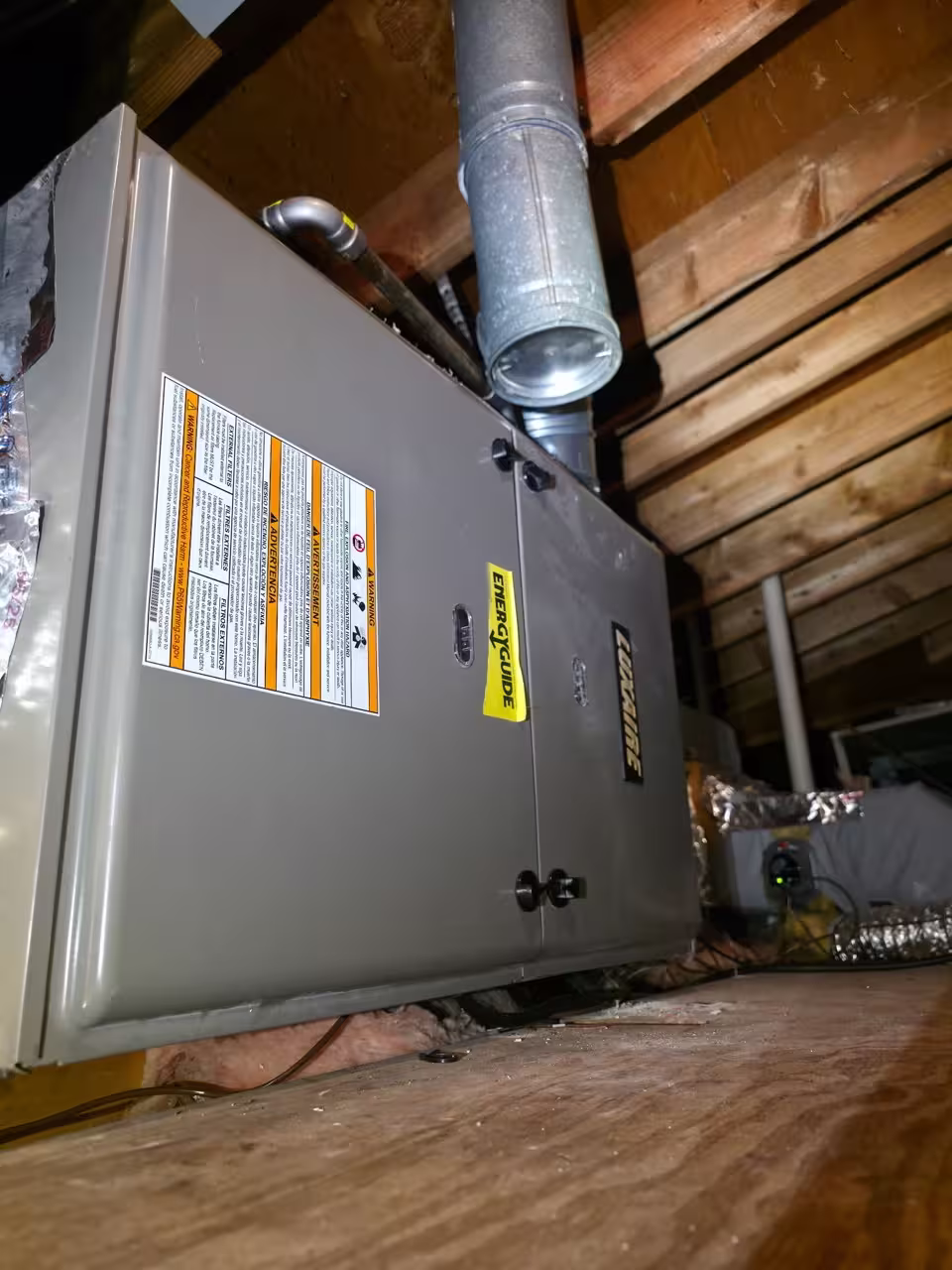 Furnace and air handler installed in a residential attic