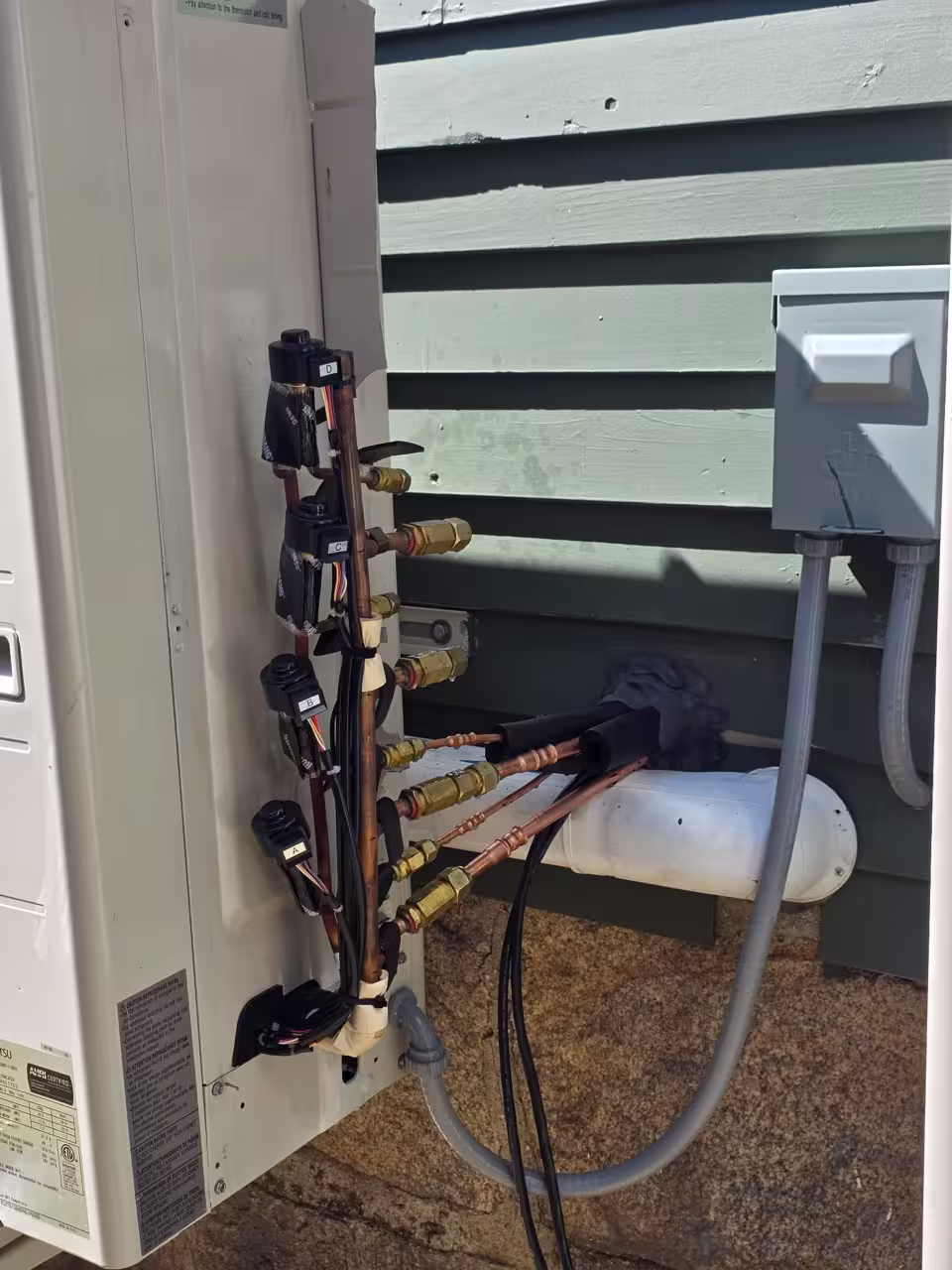 Outdoor mini split condenser with the service panel open for diagnosis