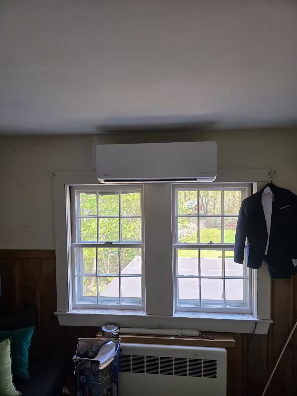 Wall-mounted ductless mini split installed above a window